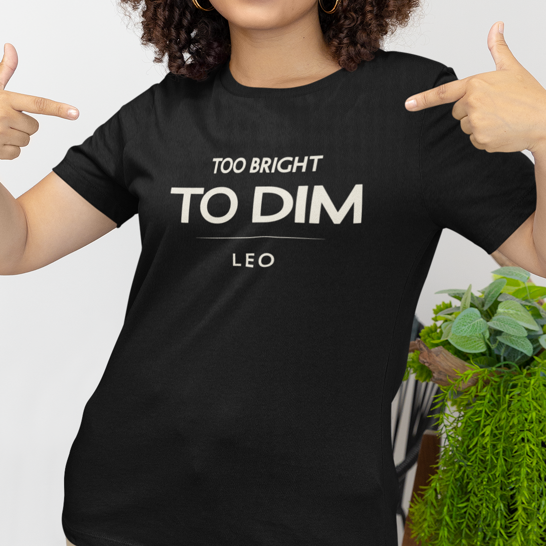 Model wearing Leo zodiac t-shirt with bold “Too Bright to Dim” typography quote