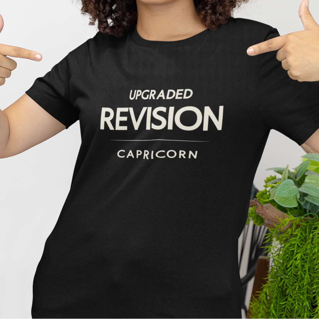 Model wearing Capricorn zodiac t-shirt with “Upgraded Revision” typography quote design