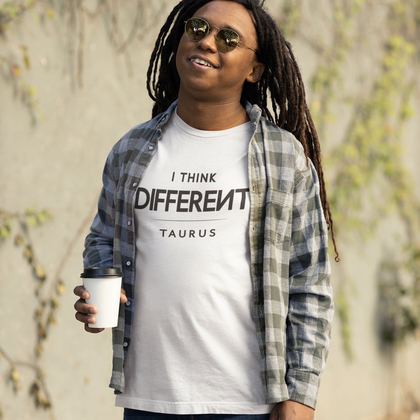 Model wearing Taurus zodiac t-shirt with “I Think Different” typography quote design