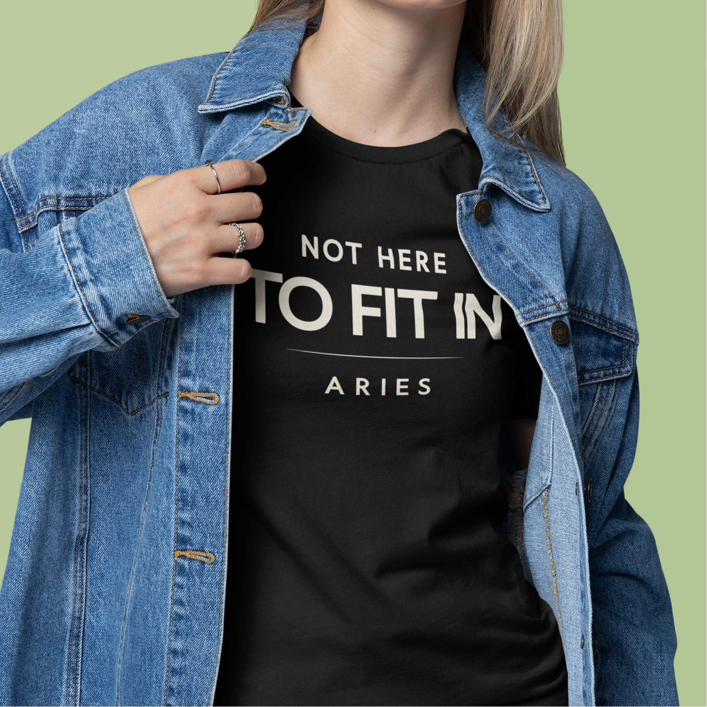 Model wearing Aries zodiac t-shirt with “Not Here to Fit In” typography quote