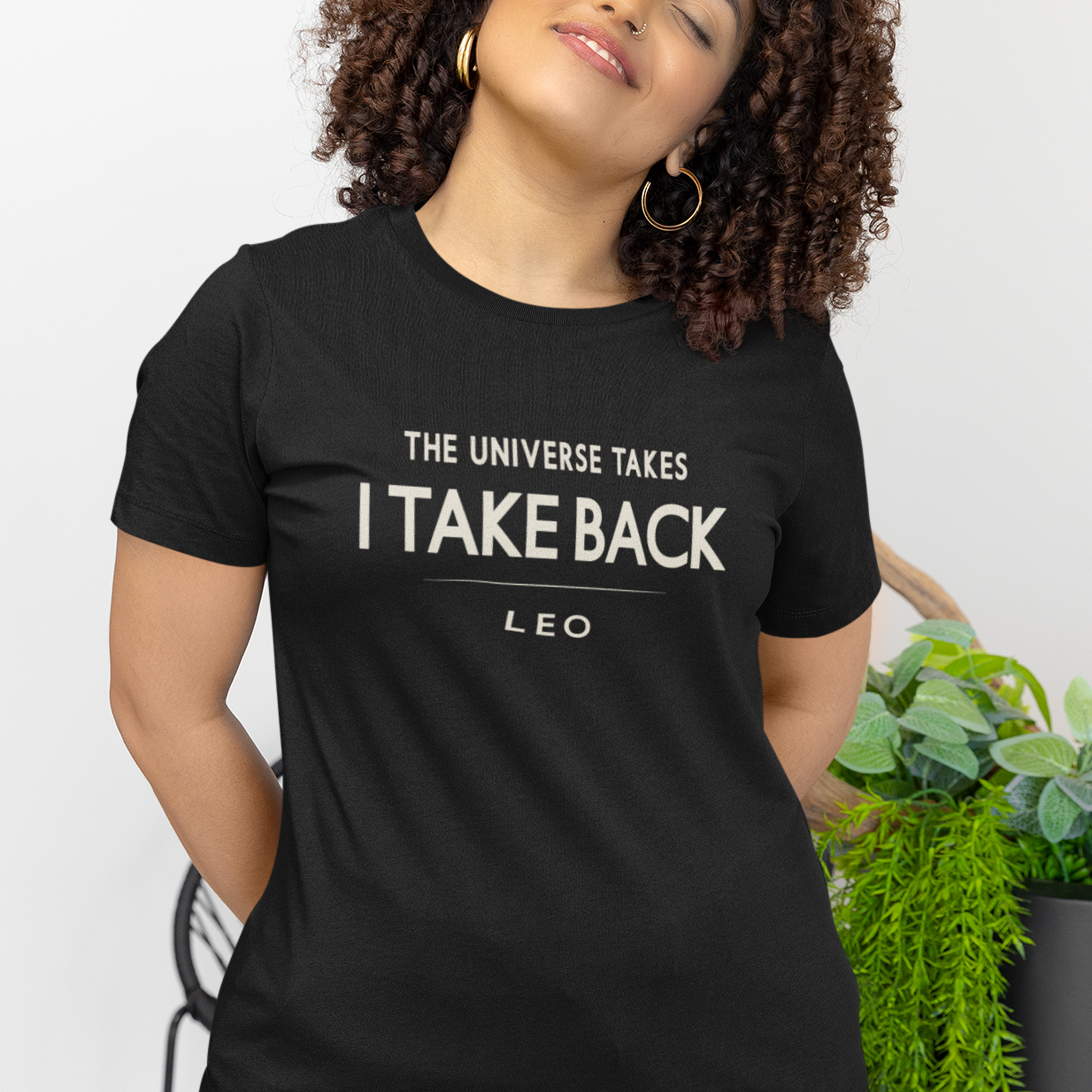 Model wearing Leo zodiac t-shirt with “The Universe Takes I Take Back” bold typography quote