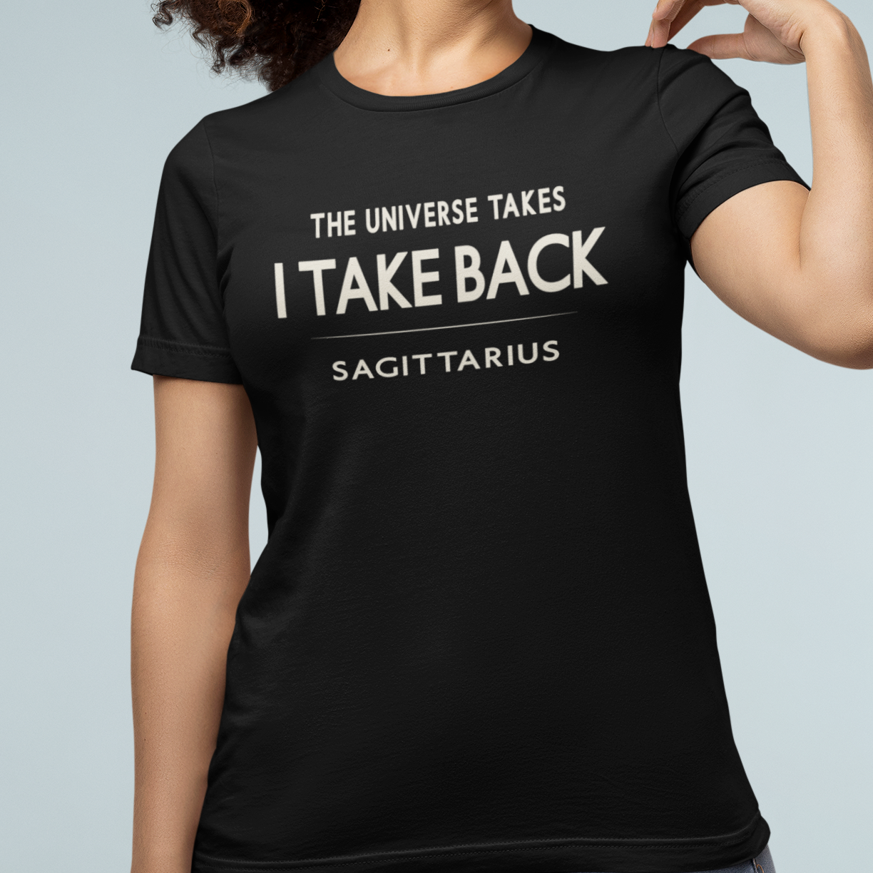 Model wearing Sagittarius zodiac t-shirt with “The Universe Takes I Take Back” typography quote