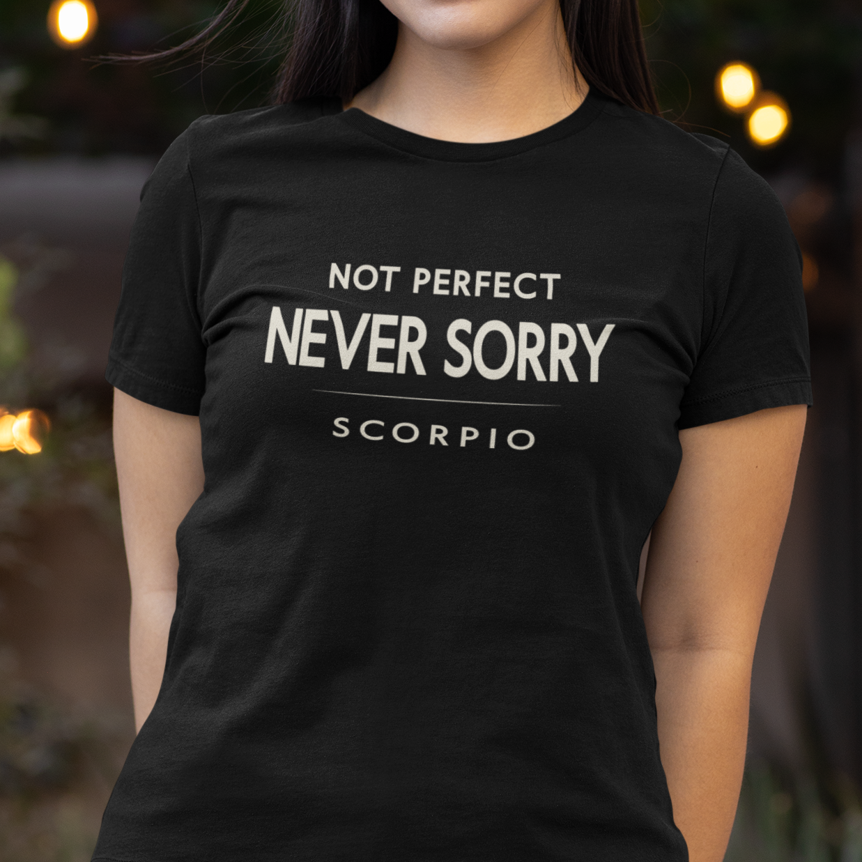Model wearing Scorpio zodiac t-shirt with “Not Perfect Never Sorry” typography quote design