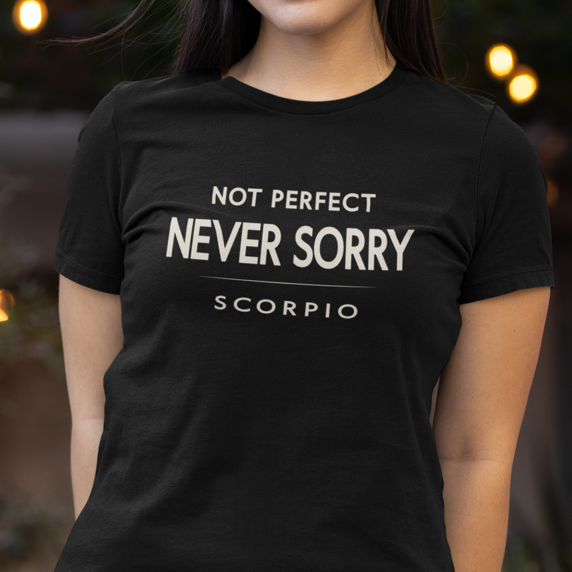 Model wearing Scorpio zodiac t-shirt with “Not Perfect Never Sorry” typography quote design