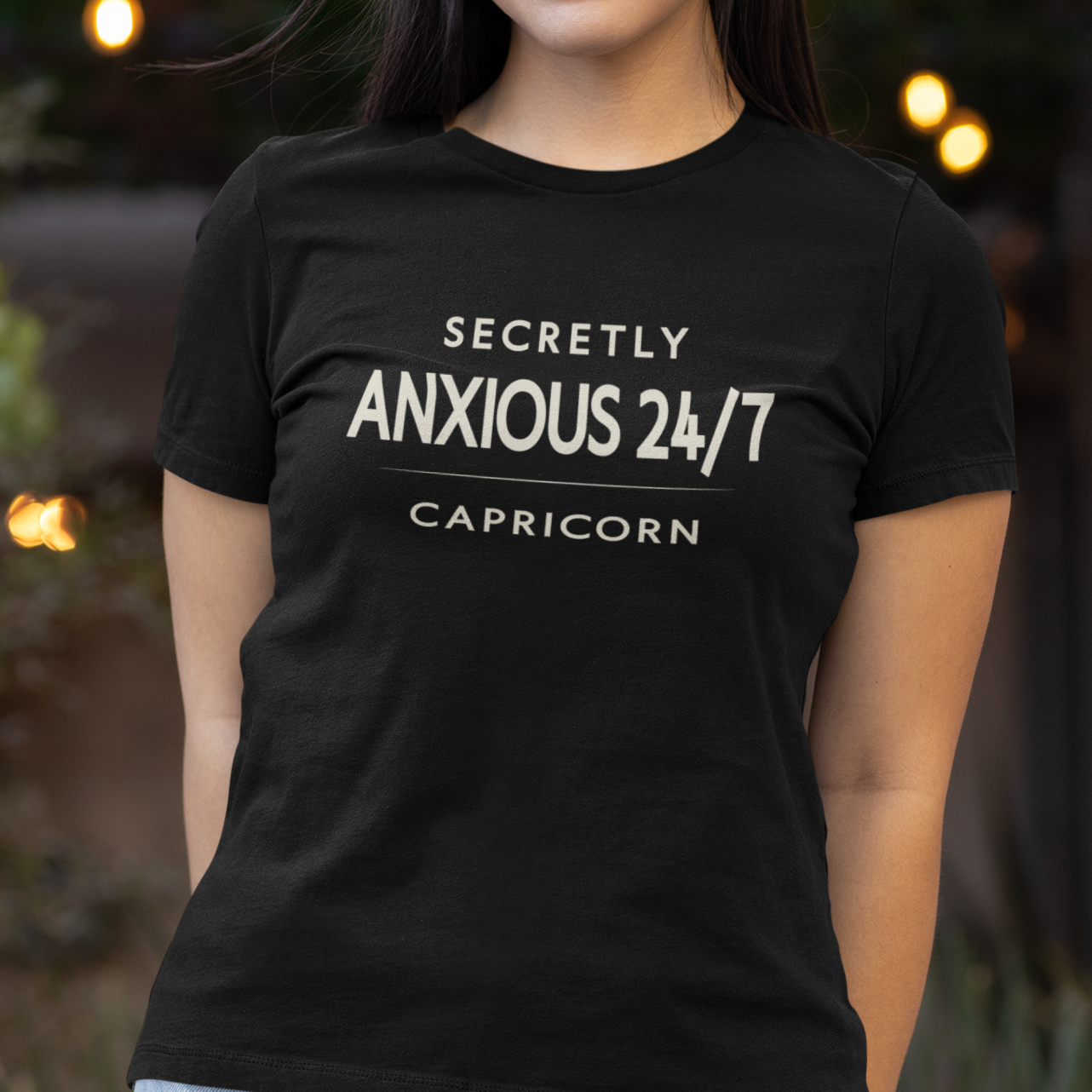 Model wearing Capricorn zodiac t-shirt with “Secretly Anxious 24/7” typography quote
