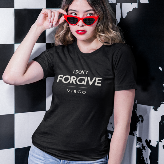 Model wearing black Virgo zodiac t-shirt with “I don’t forgive” bold typography, red sunglasses, and checkered background