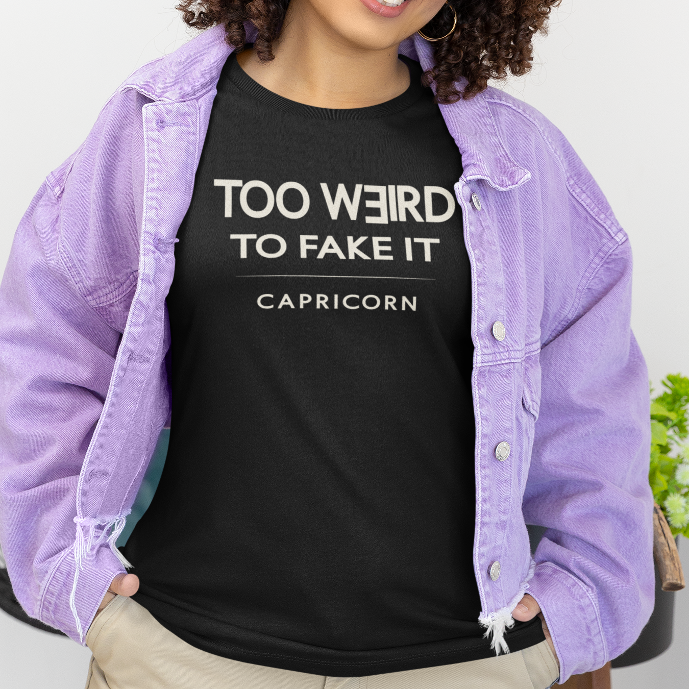 Model wearing Capricorn zodiac t-shirt with “Too Weird to Fake It” typography quote design