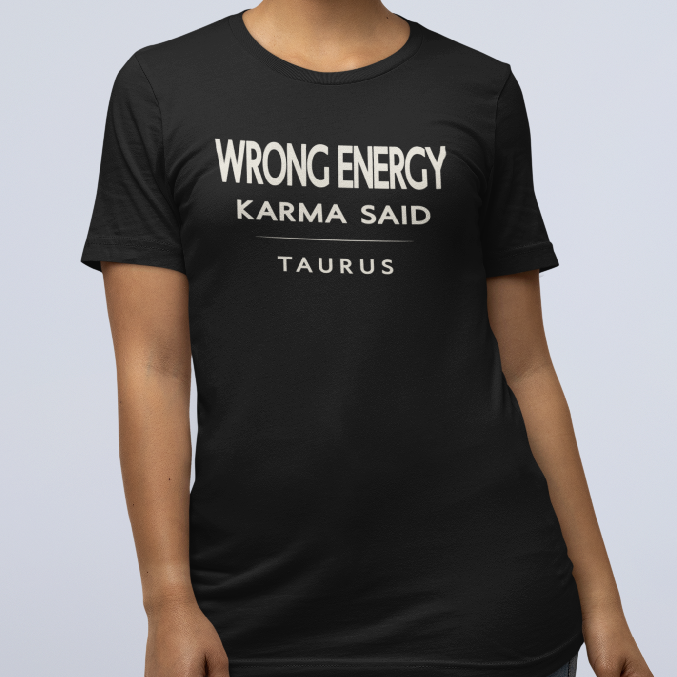 Model wearing Taurus zodiac t-shirt with “Wrong Energy Karma Said” typography quote design