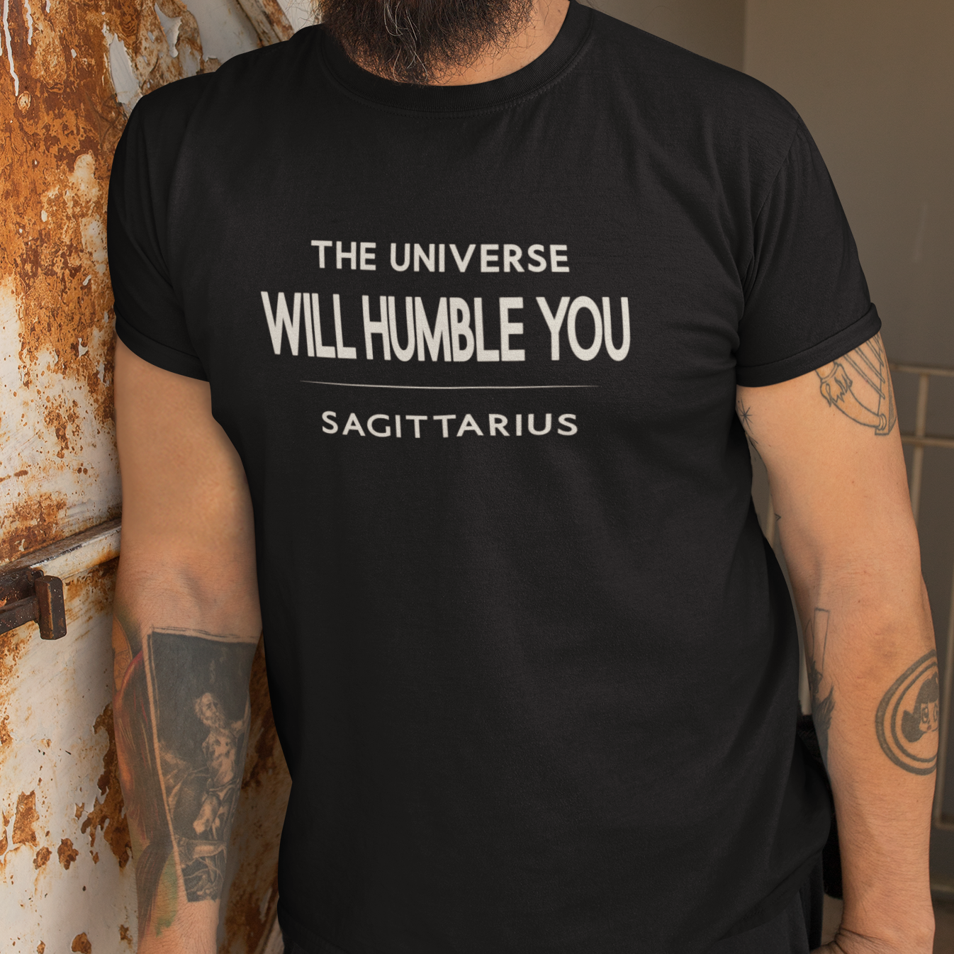 Model wearing Sagittarius zodiac t-shirt with “The Universe Will Humble You” typography quote