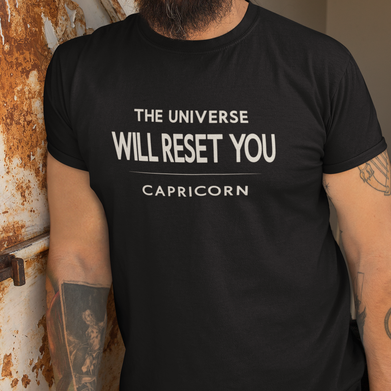 Model wearing Capricorn zodiac t-shirt with “The Universe Will Reset You” typography quote