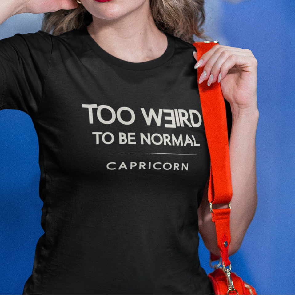 Model wearing Capricorn zodiac t-shirt with “Too Weird to Be Normal” typography quote design