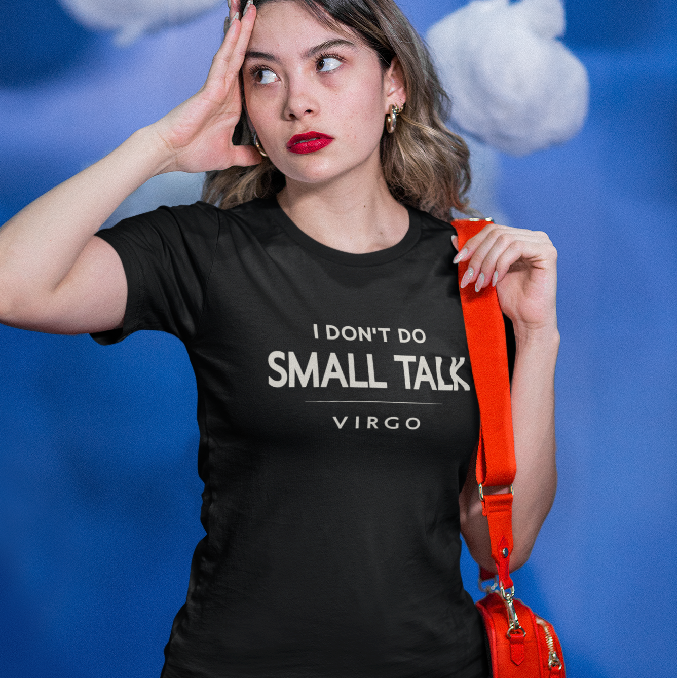 Model wearing black Virgo zodiac t-shirt “I don’t do small talk” with orange bag strap