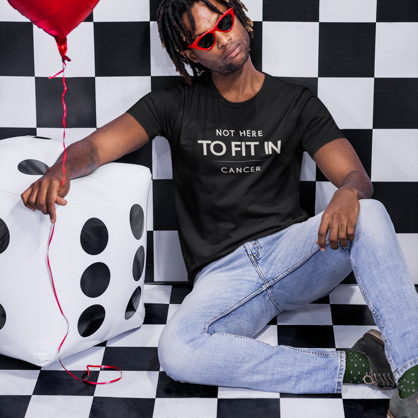 Model wearing Cancer zodiac t-shirt with “Not Here to Fit In” typography quote design