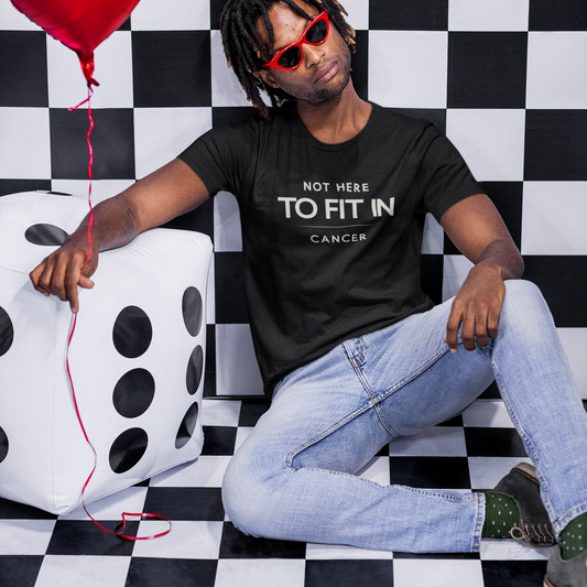 Model wearing Cancer zodiac t-shirt with “Not Here to Fit In” typography quote design