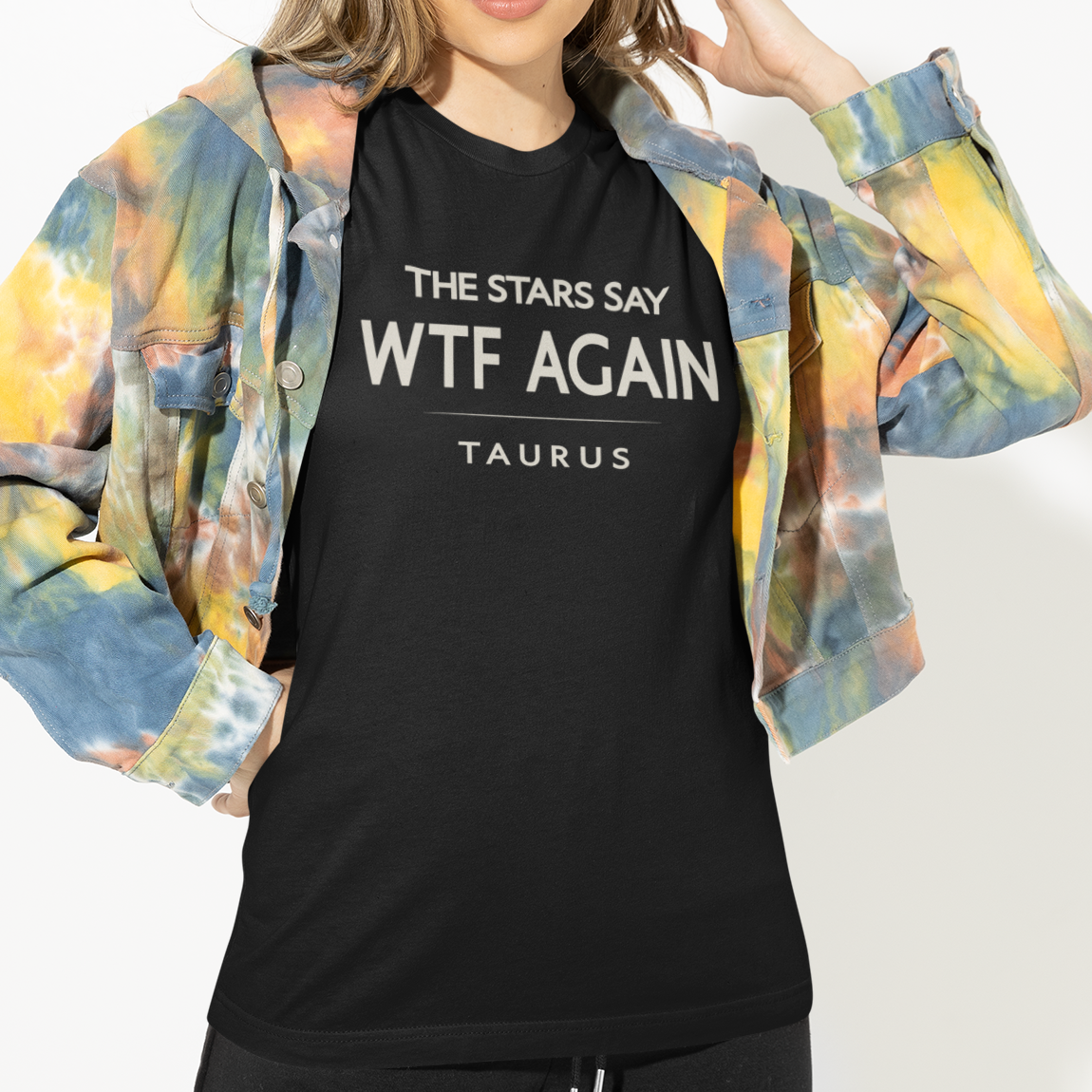 Model wearing Taurus zodiac t-shirt with “The Stars Say WTF Again” typography quote design